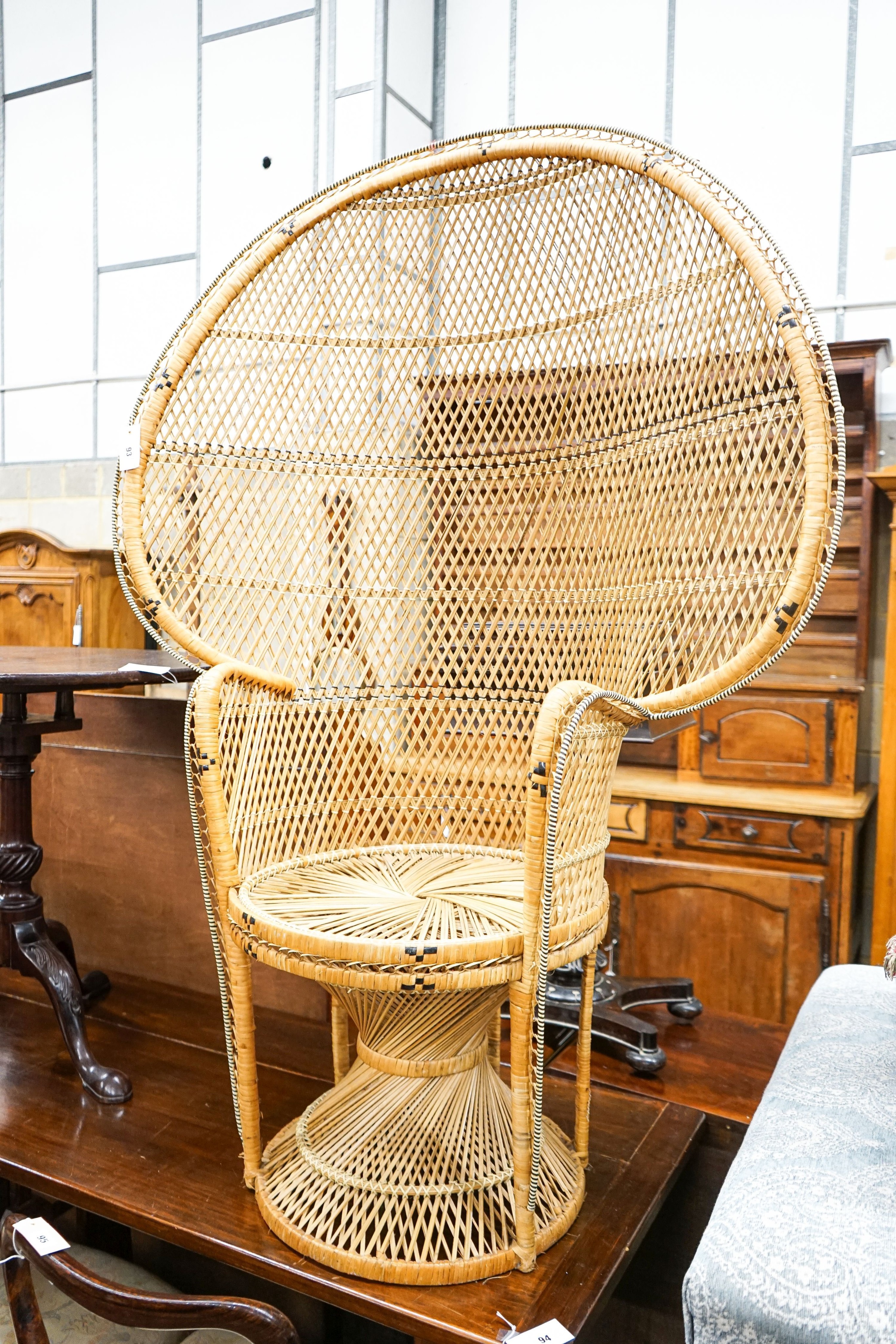 A caned 'peacock' chair, width 107cm, height 150cm